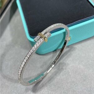 Tiffany & Co. Silver Pavé Bangle with Gold Cross Accent